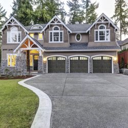Luxurious blue home with three attached garage spaces
